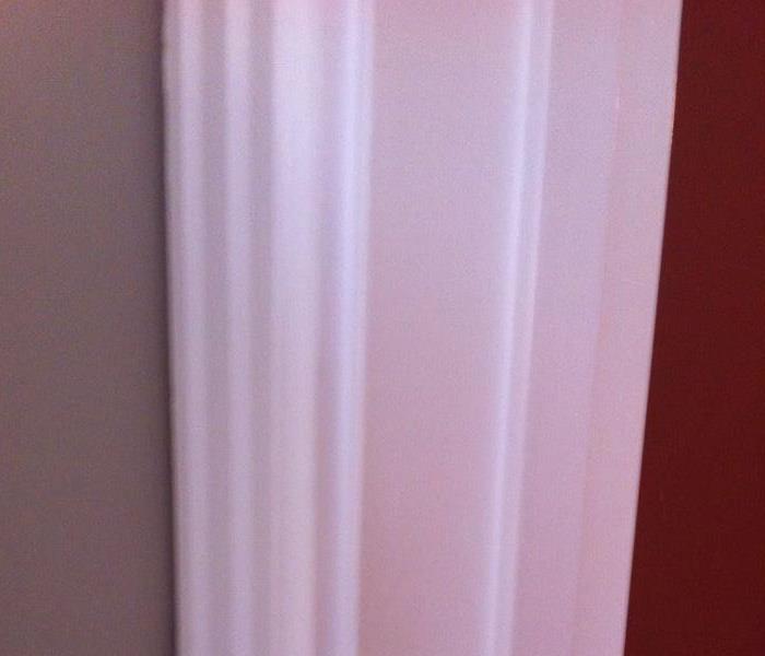 Photo of the same wall and door frame after cleaning