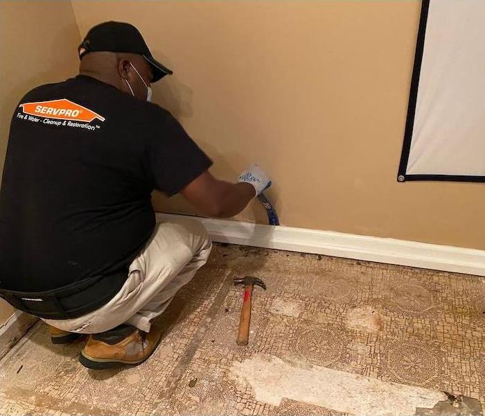 SERVPRO technician with baseboard removal equipment 