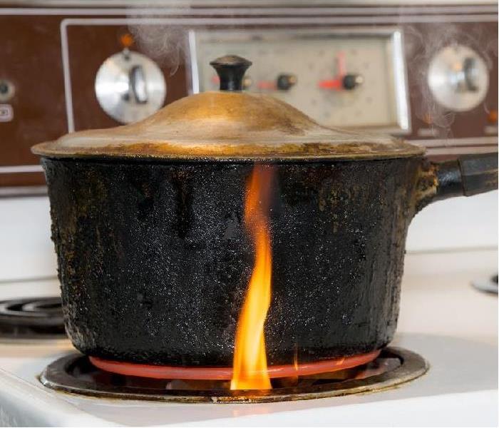 fire starting under pan on stove