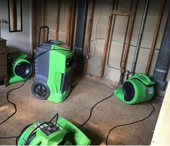 water damaged room; drywall removed; SERVPRO drying equipment being used 