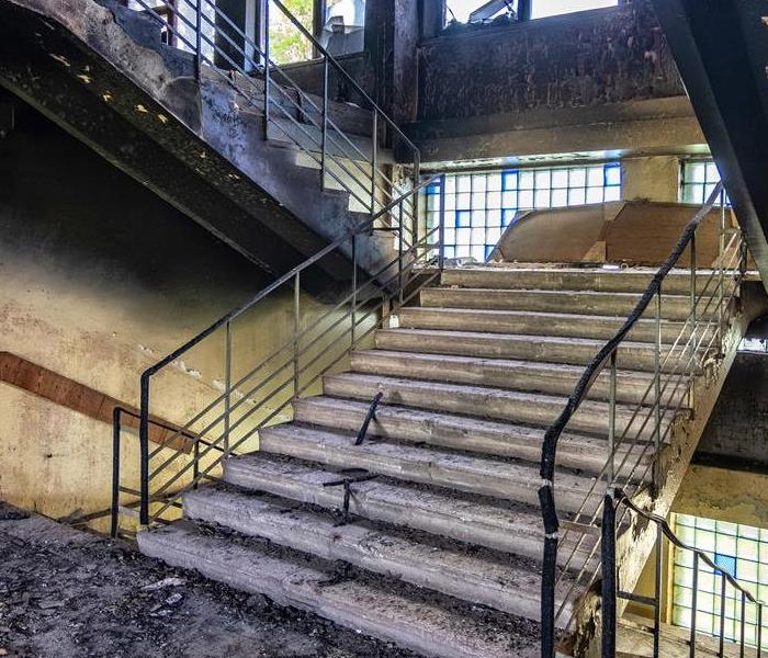 Stairs in a building with fire and soot damage